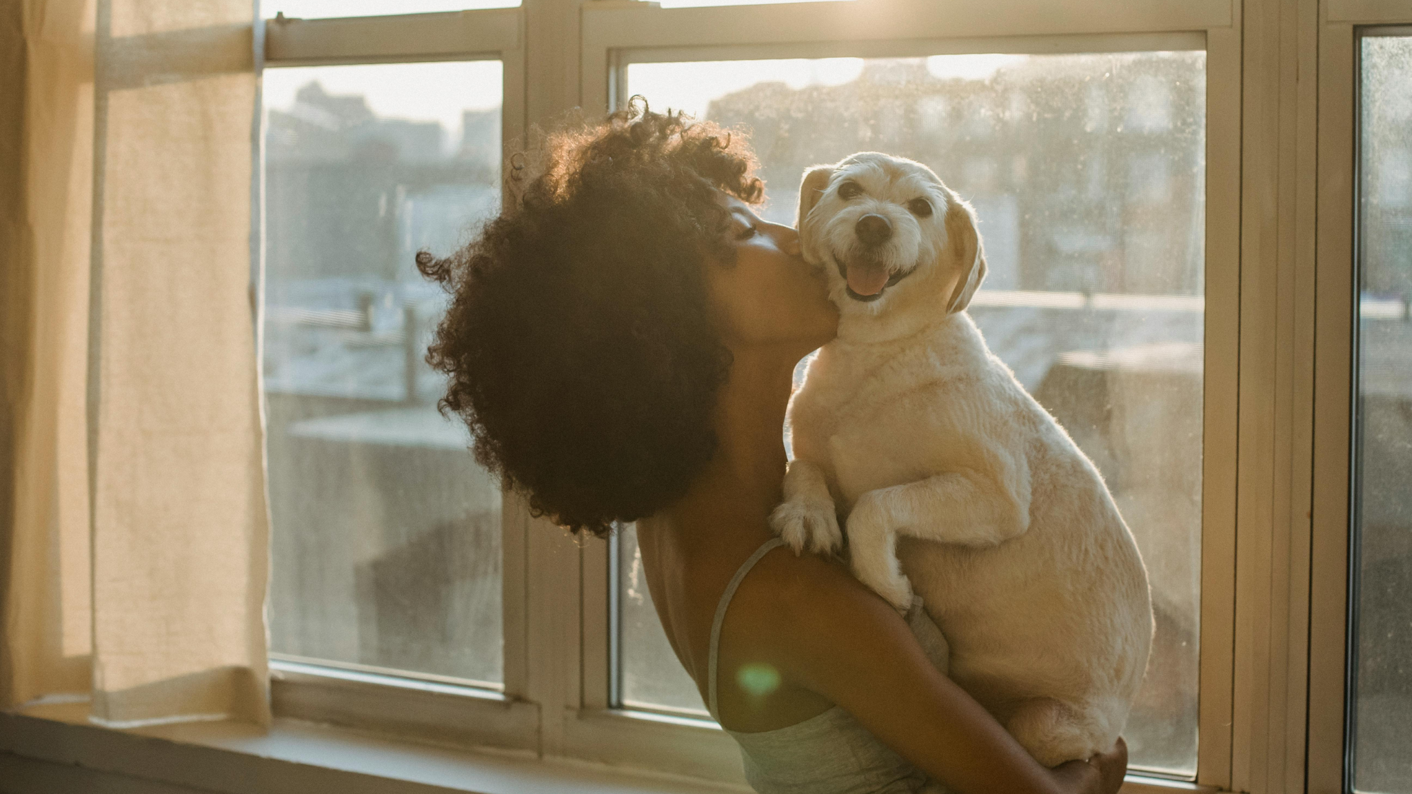 Happy woman hugging her happy puppy