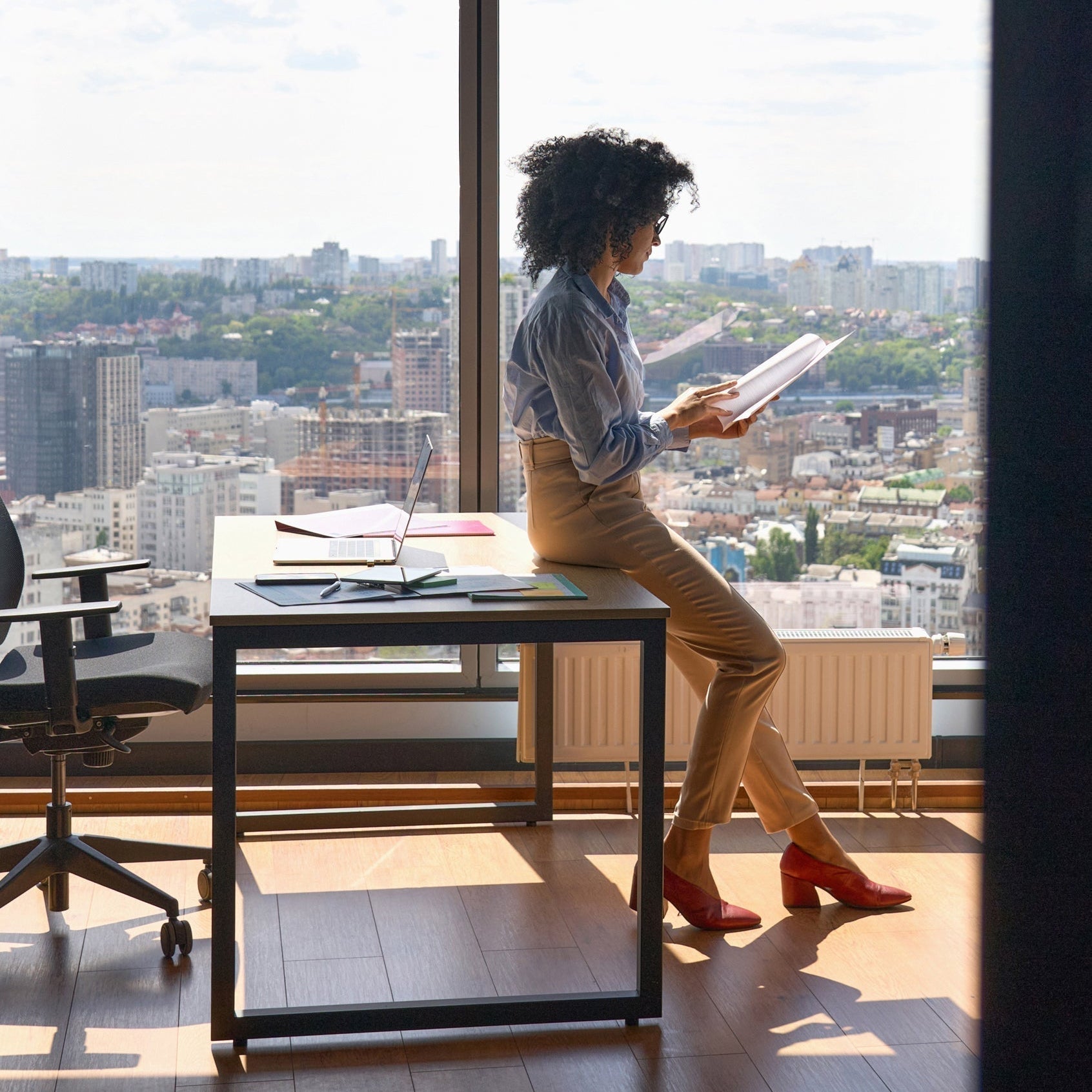 Woman sitting office reading report_Make your job work for you_career and money_VERGE Lifestyle Mgazine Online_2