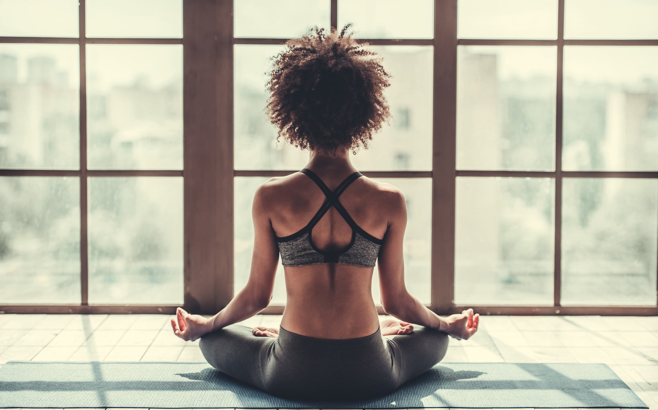 Woman Meditating By Window_Bring Outdoors in For Mental Health_VERGE Lifestyle Magazine_Boho Chic Issue
