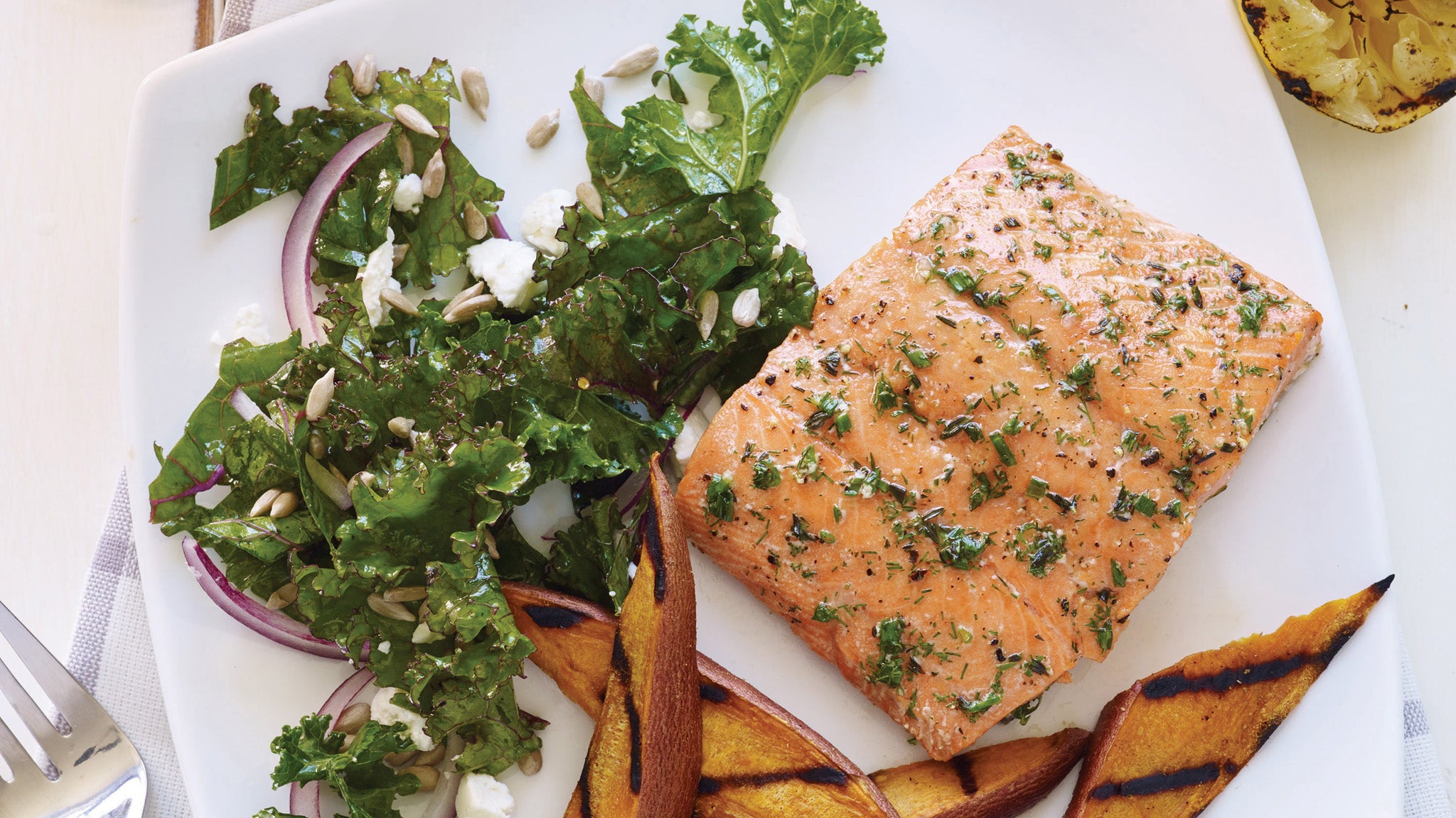 Salmon, kale and sweet potato fries recipe for eating seafood after a workout.