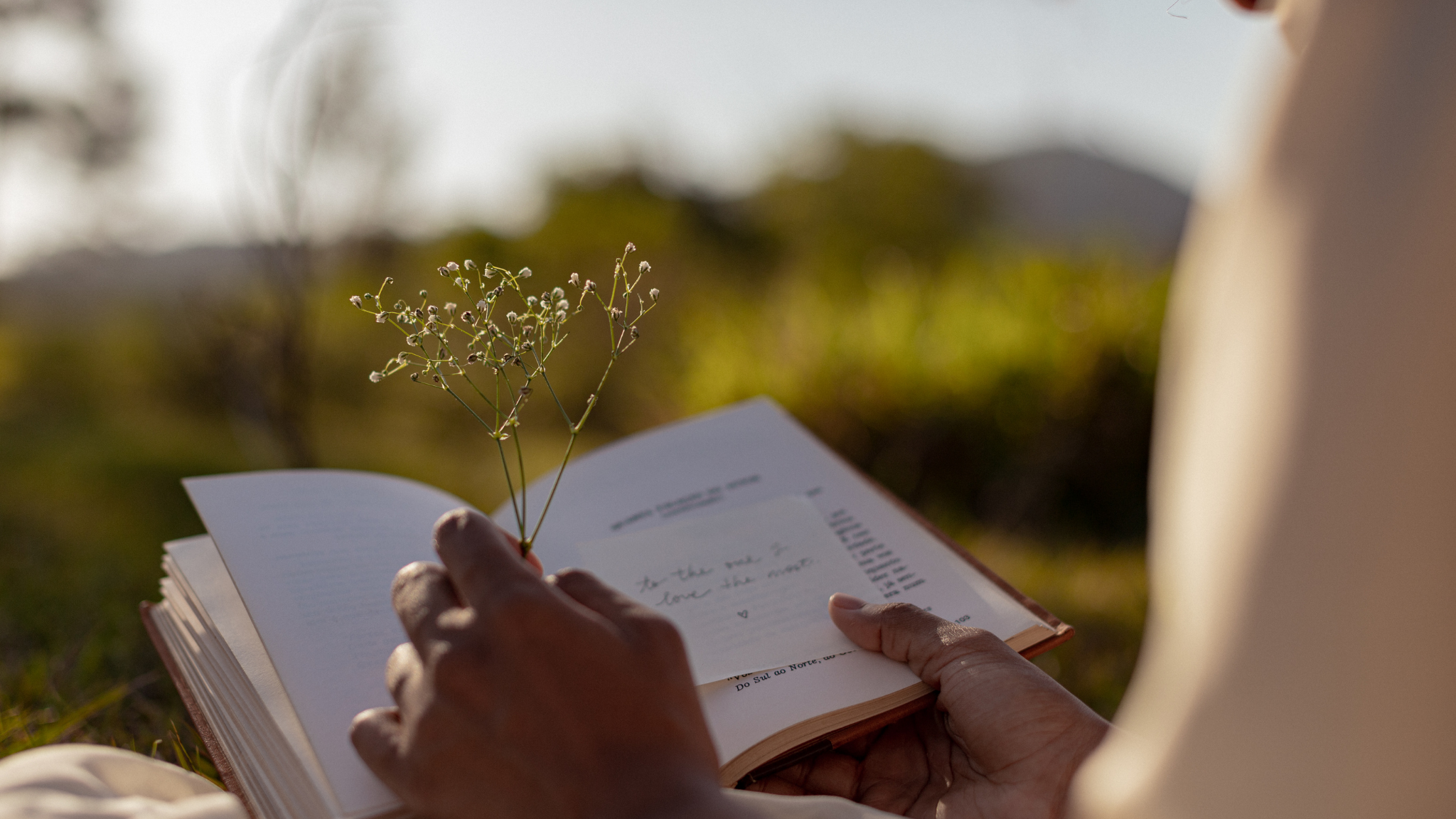 Woman holding flower and book for personal growth - VERGE Lifestyle Online Bookstore 